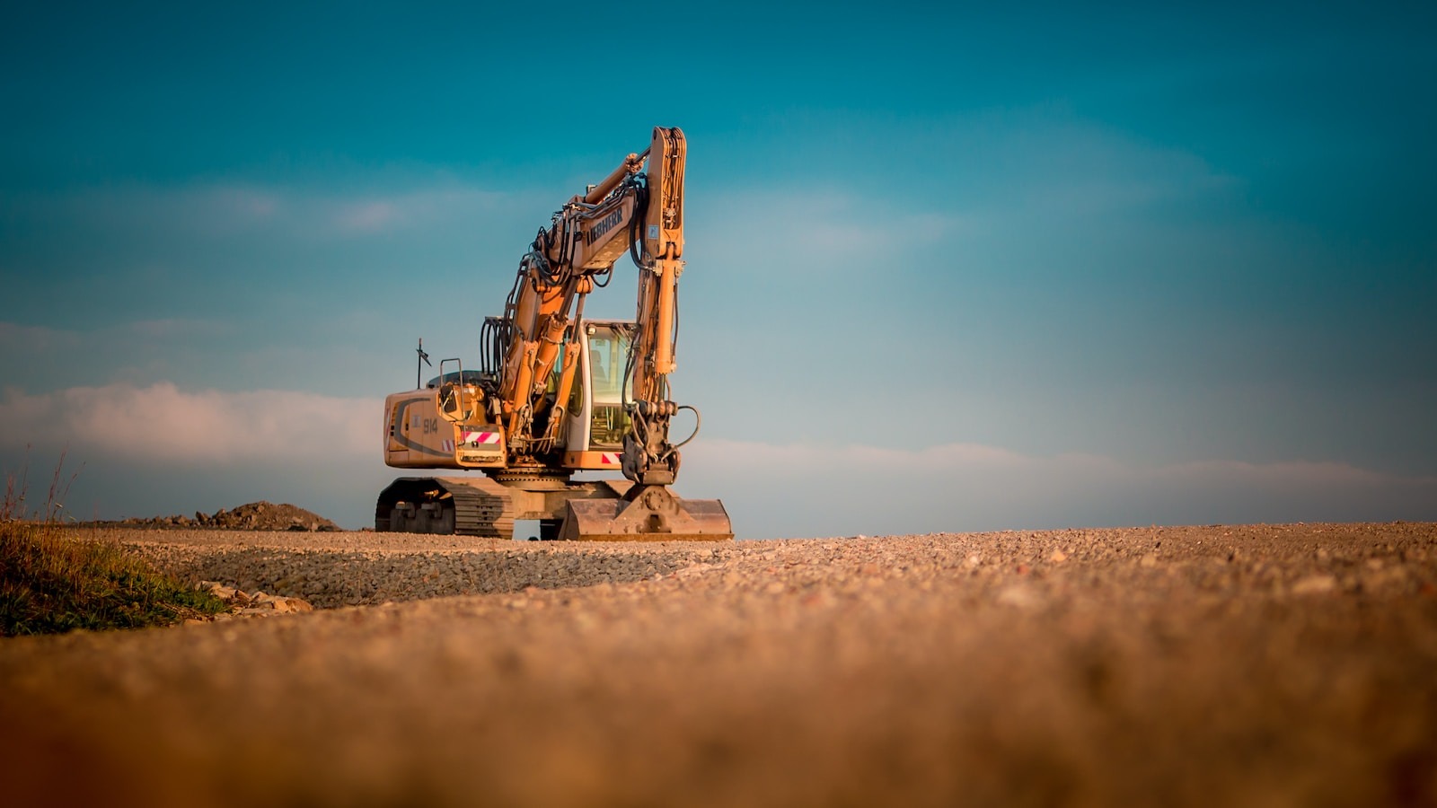 yellow and black excavator on brown sand during daytime